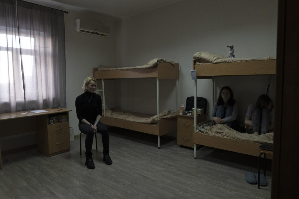 Olga Kiselyova, left, and her daughters Eva and Mila, right, sit in their temporary room in the volunteer shelter "Center of Hope and Recovery" in Kyiv, on Feb. 10, 2023. Olga and her daughters are refugees from the small coal-mining town of Vuhledar on Ukraine's eastern front line which has emerged as a critical hot spot in the fight for Donetsk province. Securing the town would give both Ukrainian forces and Russian troops a tactical upper hand in the greater battle for the Donbas region. (AP Photo/Vasilisa Stepanenko)