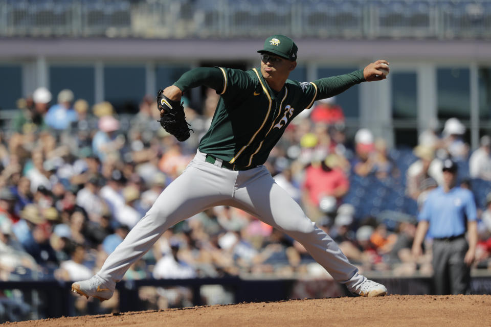 FILE - In this May 7, 2020, file photo, Oakland Athletics starting pitcher Jesus Luzardo throws against the Seattle Mariners during a spring training baseball game in Peoria, Ariz. Luzardo broke into the majors in September, striking out 16 in 12 innings and recording two saves in six relief appearances. But the A’s think his future is in their rotation. (AP Photo/Elaine Thompson, File)