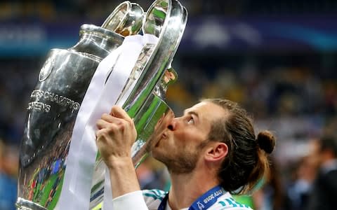 Gareth Bale kisses the trophy - Credit: reuters