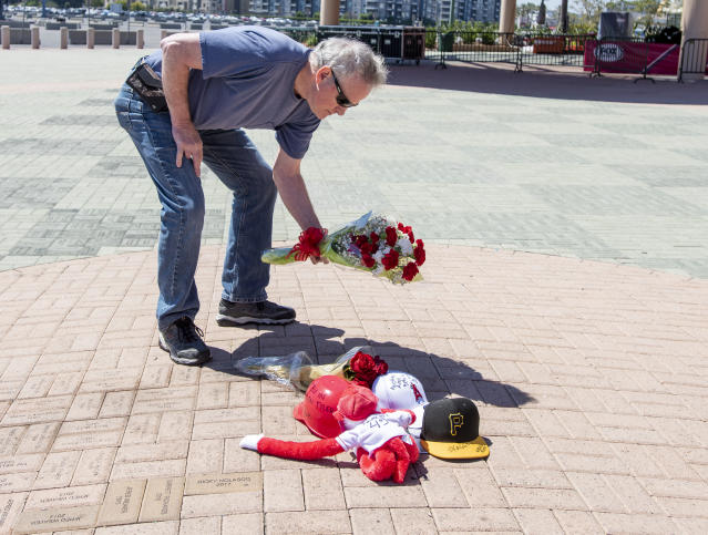 Miguel Gonzalez places a hat at a memorial for Los Angeles Angels pitcher Tyler  Skaggs outside Angel Stadium in Anaheim, Calif., Tuesday, July 2, 2019. The  27-year-old left-hander died in his Texas