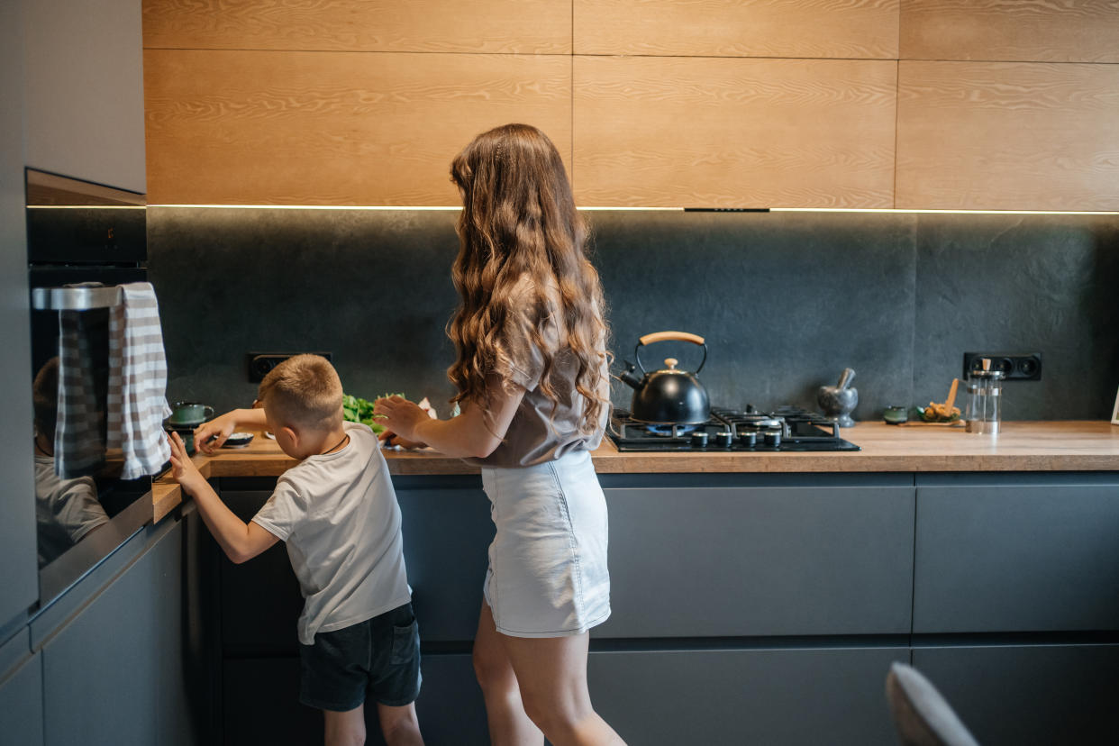 A mother and child prepare food for dinner in a modern kitchen. Gas stoves have come under scrutiny after a new study linked use to childhood asthma cases. 