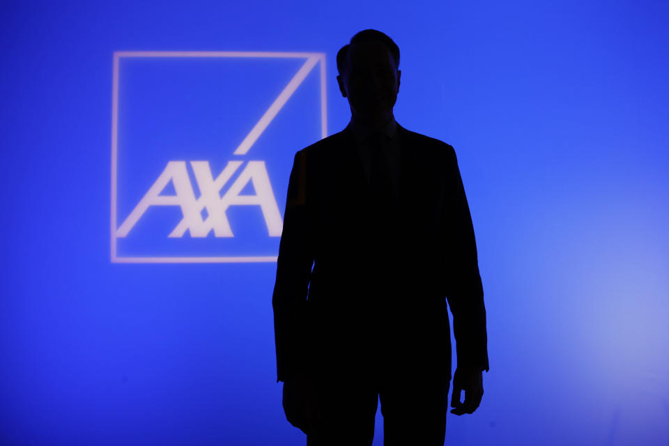 The logo of AXA Group with the shadow of Thomas Buberl, CEO of French Insurer AXA Group, posing prior to the company's 2017 annual results presentation, in Paris, France, Thursday, Feb. 22, 2018. (AP Photo/Francois Mori)