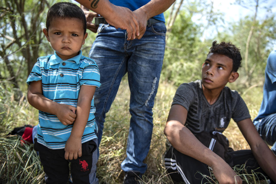 Children wait to be searched after being detained by Border Patrol 