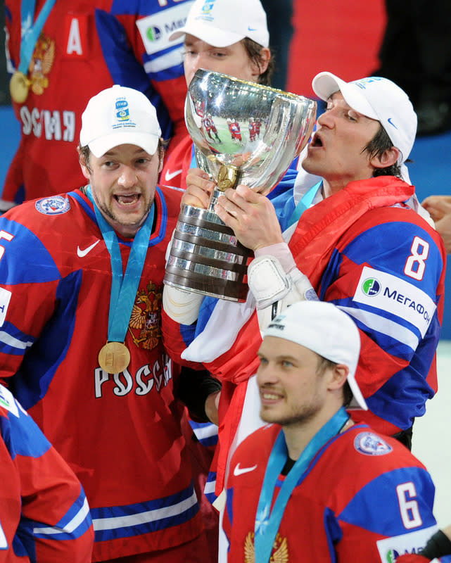 Russian Alexander Ovechkin kisses the trophy, as players celebrate after a final game of the IIHF International Ice Hockey World Championship in Helsinki on May 20, 2012, as Team Russia defeated team Slovakia 6-2 . AFP PHOTO/ ALEXANDER NEMENOVALEXANDER NEMENOV/AFP/GettyImages