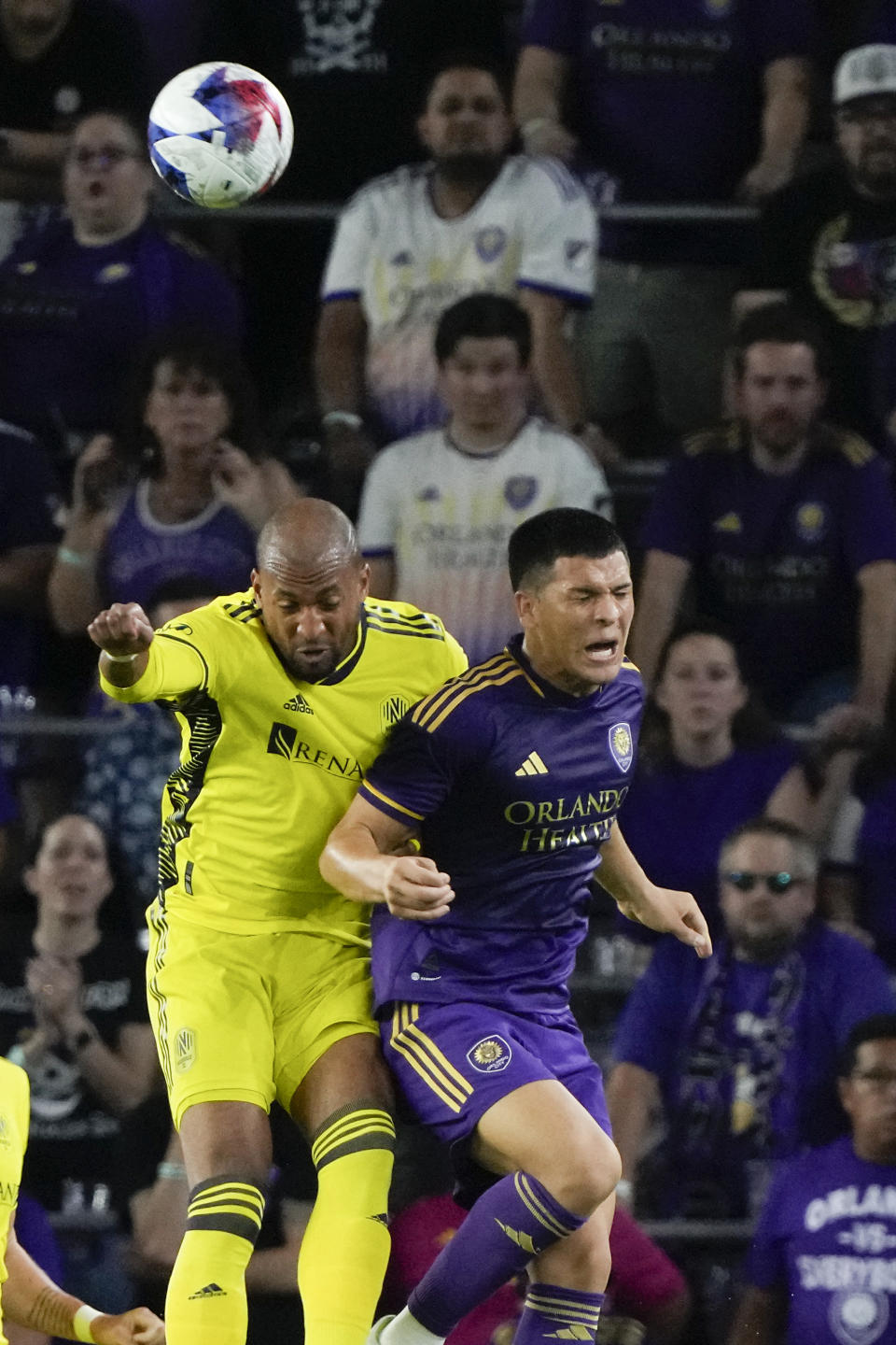 Nashville SC forward Teal Bunbury, left, and Orlando City midfielder Cesar Araujo go up for a head ball during the second half of an MLS playoff soccer match, Monday, Oct. 30, 2023, in Orlando, Fla. (AP Photo/John Raoux)