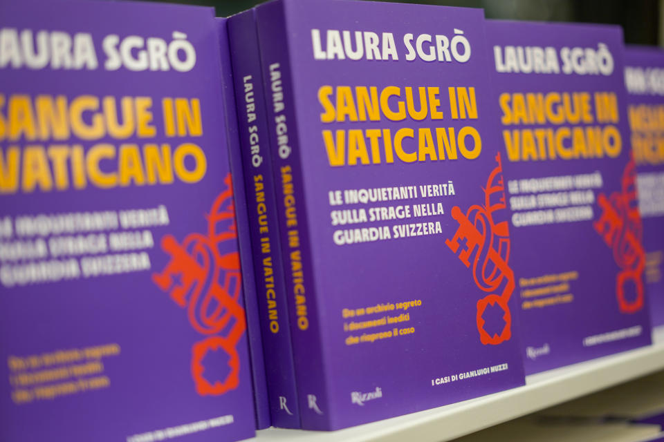 Copies of the book Sangue in Vaticano (Blood in The Vatican) by lawyer Laura Sgro', are displayed in the window of a bookshop during its launch in Rome, Tuesday, Nov. 29, 2022. The book is about the case of Swiss Guard Corporal Cedric Tornay who allegedly committed suicide in the Vatican after killing guards' commander Alois Estermann and his Venezuelan wife Gladys Meza Romero in 1998. (AP Photo/Andrew Medichini)