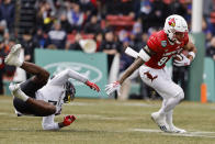 Louisville's Jaelin Carter sheds Cincinnati defender Ethan Wright as he runs with the ball during the second quarter of the Fenway Bowl NCAA college football game at Fenway Park Saturday, Dec. 17, 2022, in Boston. (AP Photo/Winslow Townson)