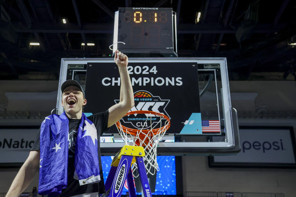 Saint Mary's guard Alex Ducas holds up a piece of net after the team's win over Gonzaga in an NCAA college basketball game for the championship of the West Coast Conference men's tournament Tuesday, March 12, 2024, in Las Vegas. (AP Photo/Ian Maule)