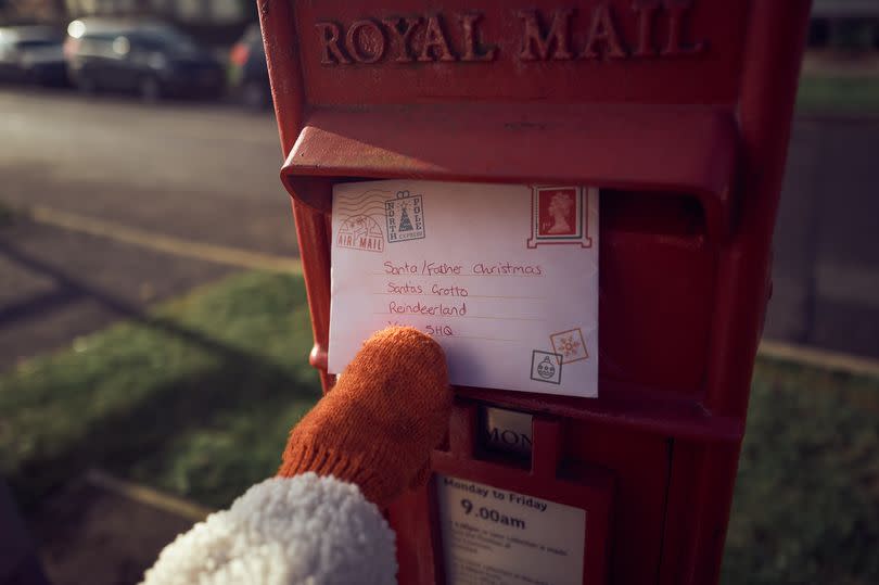 ESSEX - DECEMBER 06: Livia Cattermole, the photographer’s daughter, posts a letter to Santa via Royal Mail on December 06, 2020 in Essex, England. Writing letters to Santa Claus has been a Christmas tradition for children worldwide for many years. These letters normally contain a wish list of toys in exchange for good behaviour. (Photo by Gareth Cattermole/Getty Images)