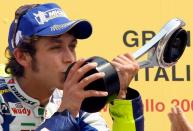 FILE PHOTO: Yamaha rider Valentino Rossi kisses the trophy after winning the Italian Grand Prix at the Mugello Circuit for the sixth straight year.