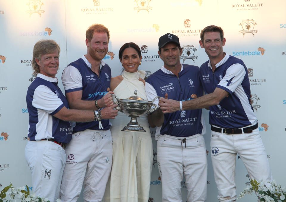 The Duchess of Sussex presents the trophy to her husband, the Duke of Sussex after his team the Royal Salute Sentebale Team defeated the Grand Champions Team, in the Royal Salute Polo Challenge, to benefit Sentebale, at The USPA National Polo Center in Wellington, Florida, US. Picture date: Friday April 12, 2024. (Photo by Yaroslav Sabitov/PA Images via Getty Images)