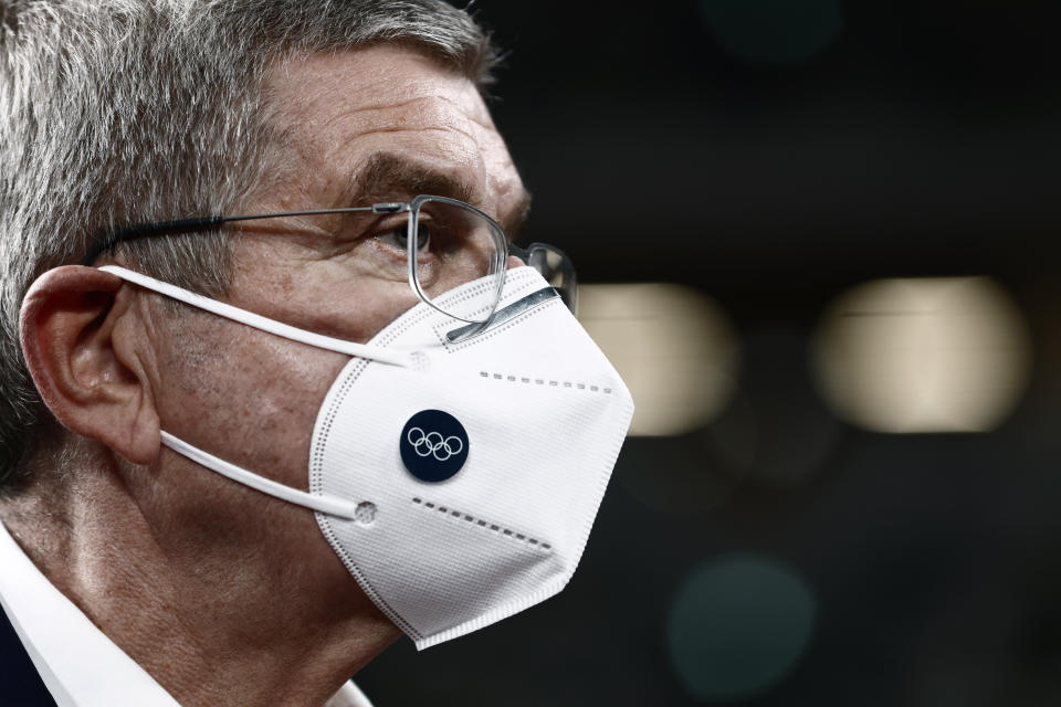 IOC President Thomas Bach speaks to media during a visit to the National Stadium, the main venue for the 2020 Olympic and Paralympic Games postponed until July 2021 due to the coronavirus pandemic, in Tokyo Tuesday, Nov. 17, 2020. Bach said during this week's trip to Tokyo that he is “encouraging” all Olympic “participants” and fans to be vaccinated - if one becomes available - if they are going to attend next year's Tokyo Olympics. (Behrouz Mehri/Pool Photo via AP)