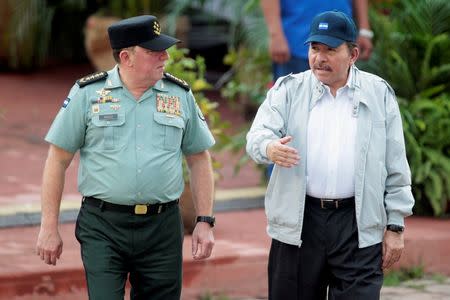 Nicaragua's President Daniel Ortega (R) speaks with Commander in Chief of the Nicaraguan army General Julio Cesar Aviles during a military parade commemorating the 37th anniversary of the founding of the army, in Managua September 3,2016.RUETERS/Oswaldo Rivas