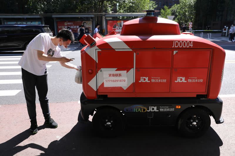 Autonomous delivery vehicle by JD Logistics operates on a street in Beijing