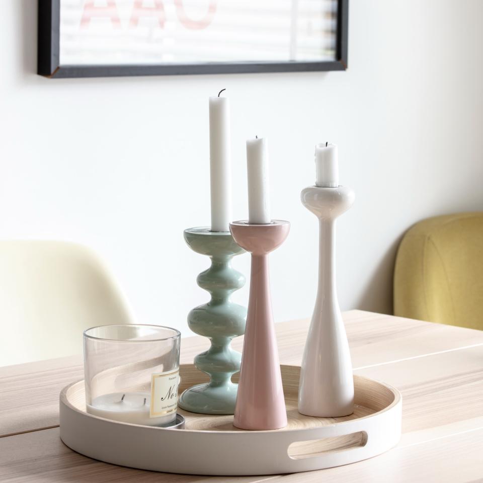 A tray with candles on a dining table