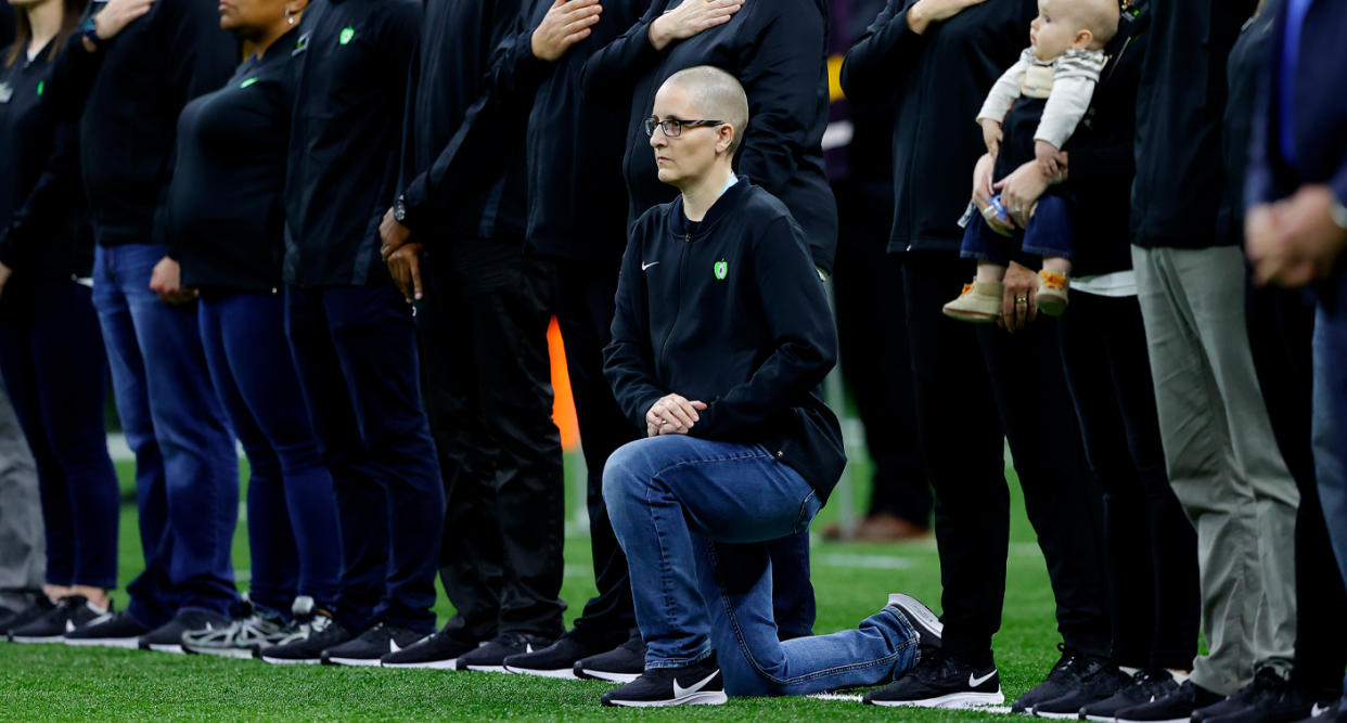 Teacher of the Year Kelly Holstine kneeled during the National Anthem at the College Football Playoff National Championship game on January 13, with President and Melania Trump in attendance. (Photo: Getty Images)  