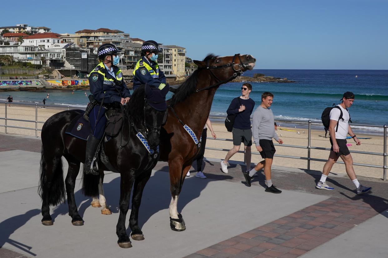 Mounted police officers patrol Bondi Beach during the lockdown (REUTERS)