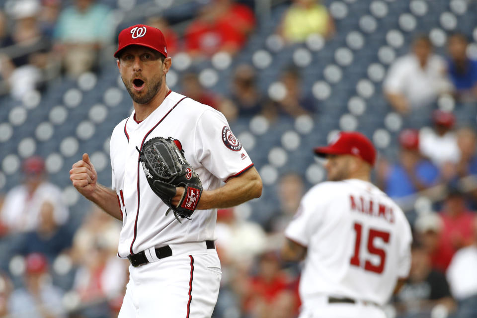 Washington Nationals starting pitcher Max Scherzer reacts after third baseman Anthony Rendon threw out Colorado Rockies' Raimel Tapia at first base on a ground ball in the second inning of a baseball game, Thursday, July 25, 2019, in Washington. (AP Photo/Patrick Semansky)