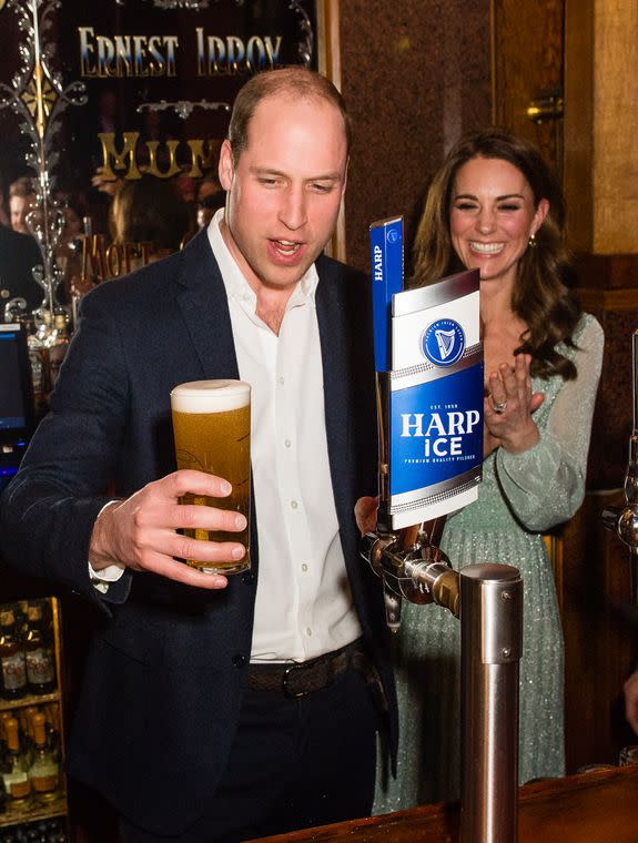 BELFAST, NORTHERN IRELAND - FEBRUARY 27: Catherine, Duchess of Cambridge looks on as Prince William, Duke of Cambridge pulls a pint off beer during a visit to Empire Music Hall Belfast on February 27, 2019 in Belfast, Northern Ireland. Prince William last visited Belfast in October 2017 without his wife, Catherine, Duchess of Cambridge, who was then pregnant with the couple's third child. This time they concentrate on the young people of Northern Ireland. Their engagements include a visit to Windsor Park Stadium, home of the Irish Football Association, activities at the Roscor Youth Village in Fermanagh, a party at the Belfast Empire Hall, Cinemagic -a charity that uses film, television and digital technologies to inspire young people and finally dropping in on a SureStart early years programme. (Photo by Samir Hussein/Samir Hussein/WireImage)