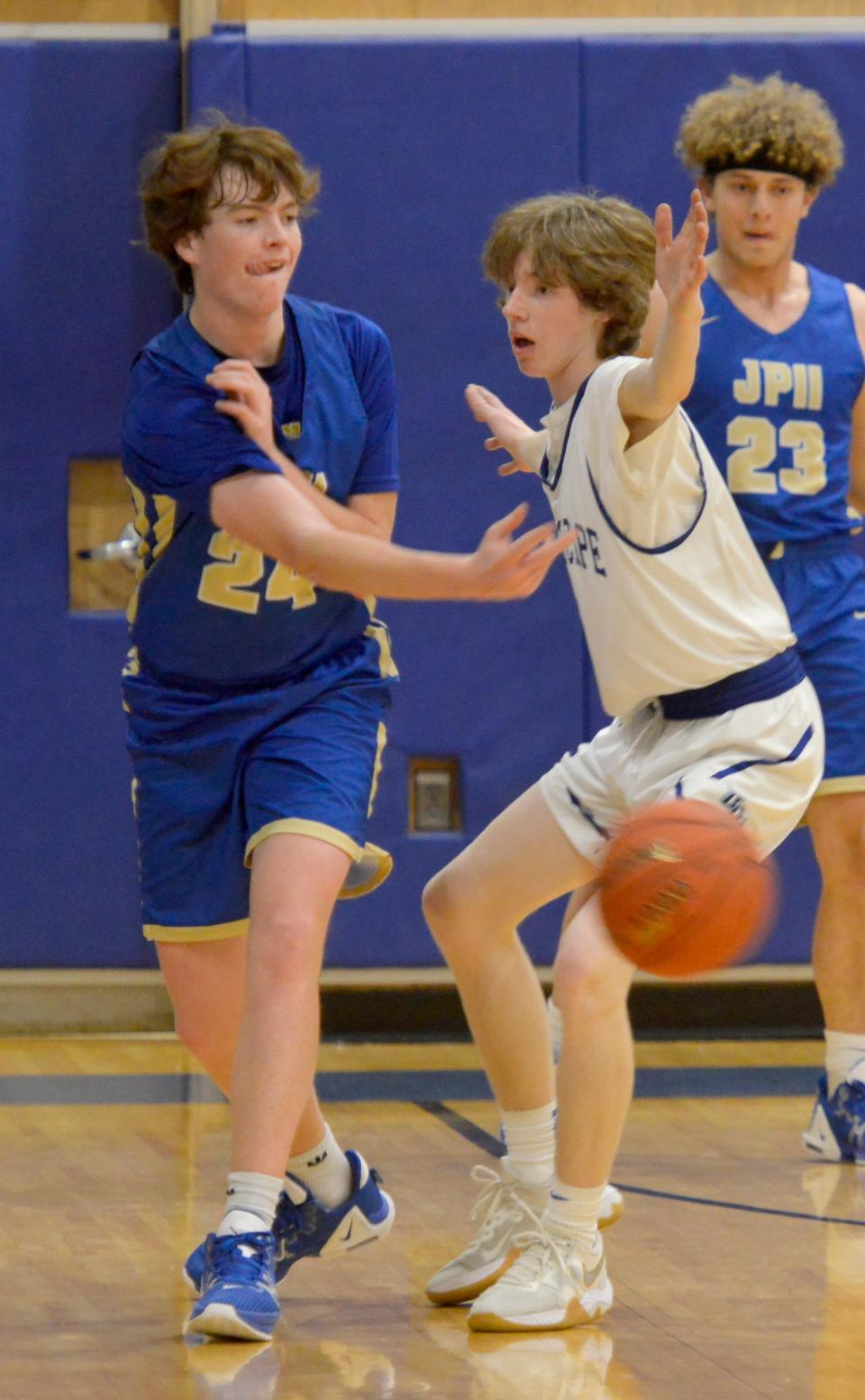 BOURNE -- 01/31/23 -- Upper Cape Tech's Patrick Accord, right, tries to block a second quarter pass by St. John Paul II's Matt Curley.