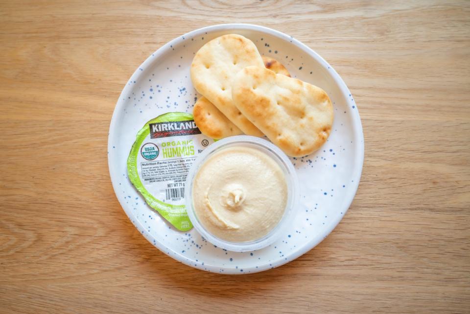 kirkland single-serve hummus on plate with small naan dippers