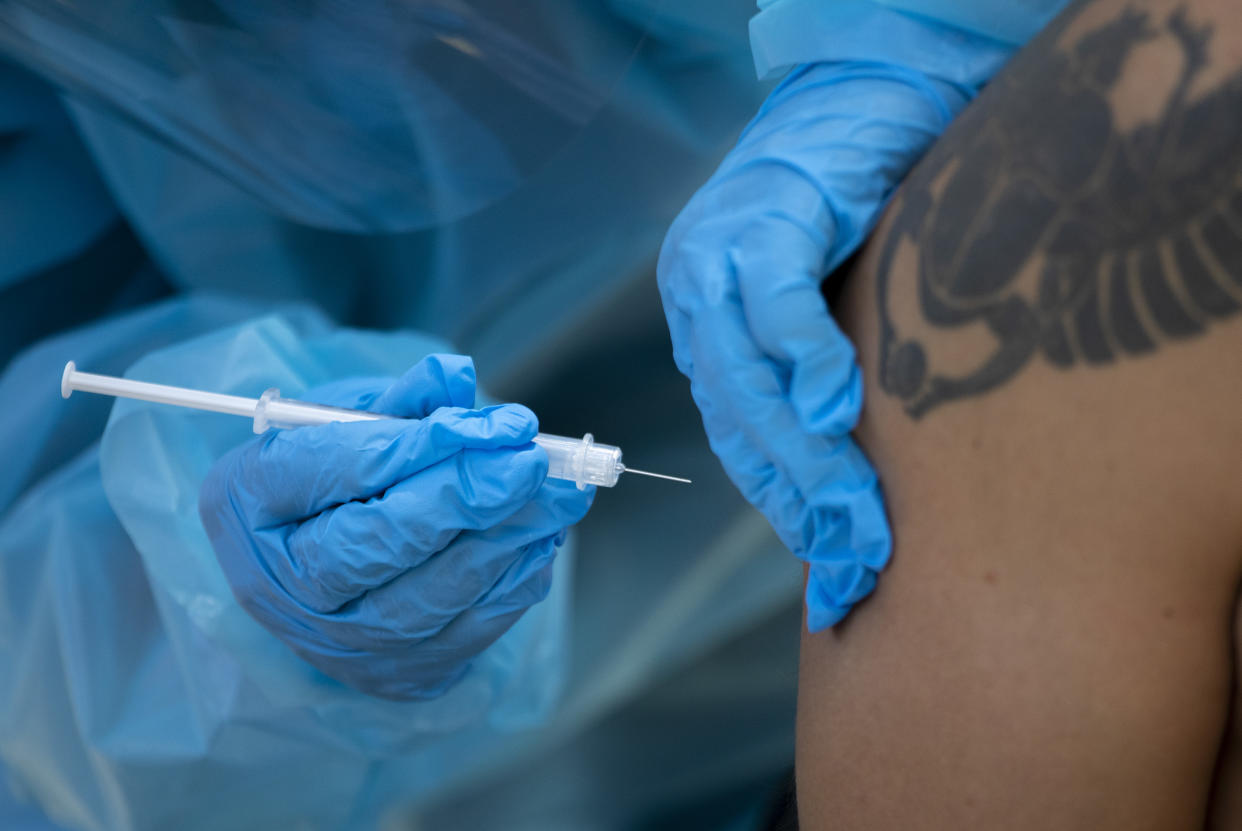 A Medical Reserve Corps volunteer administers a monkeypox vaccination.