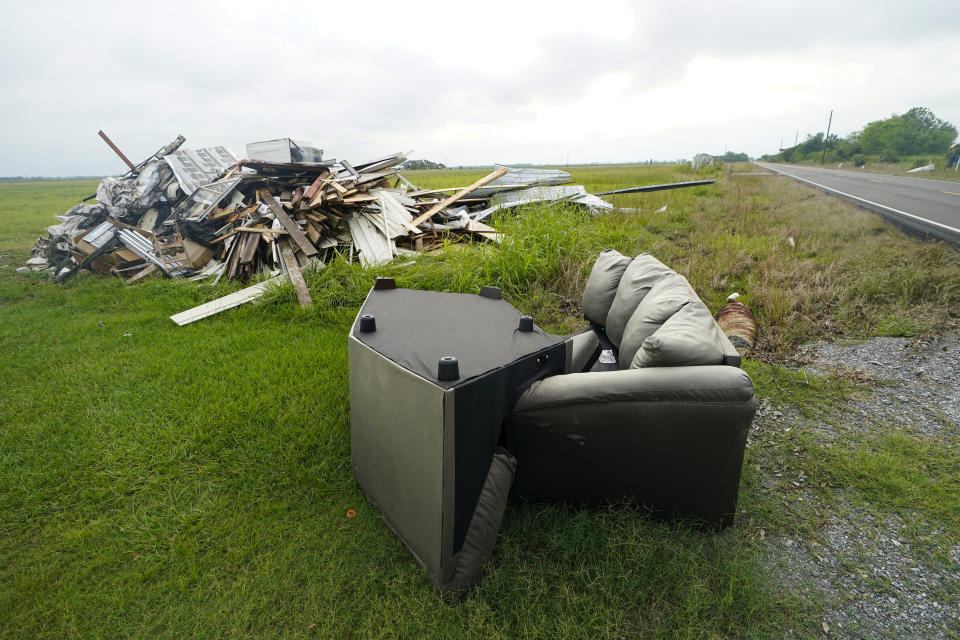 Debris from Hurricane Laura is pilled up in Bell City, La., Thursday, Oct. 8, 2020, as Hurricane Delta approached the Gulf Coast. Louisiana residents still recovering from the devastation of a powerful hurricane less than two months ago braced for another hit as Hurricane Delta steamed north through the Gulf on Thursday after swiping Mexico's Yucatan Peninsula. (AP Photo/Gerald Herbert)