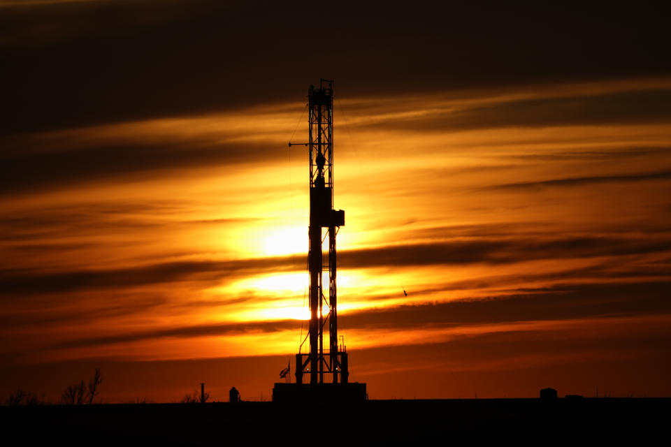 FILE - An oil drilling rig is pictured at sunset, Monday, March 7, 2022, in El Reno, Okla. A federal appeals court in New Orleans hears arguments Tuesday, May 10, 2022, about whether President Joe Biden legally suspended new oil and gas lease sales because of climate change worries. (AP Photo/Sue Ogrocki, File)