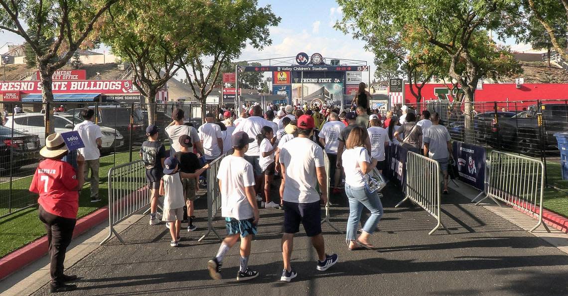 Fans begin to line up at the gate before the start of Fresno State’s home opener against Eastern Washington at Valley Children’s Stadium on Saturday, Sept. 9, 2023. Fans were encouraged to wear white for the “White out” game.