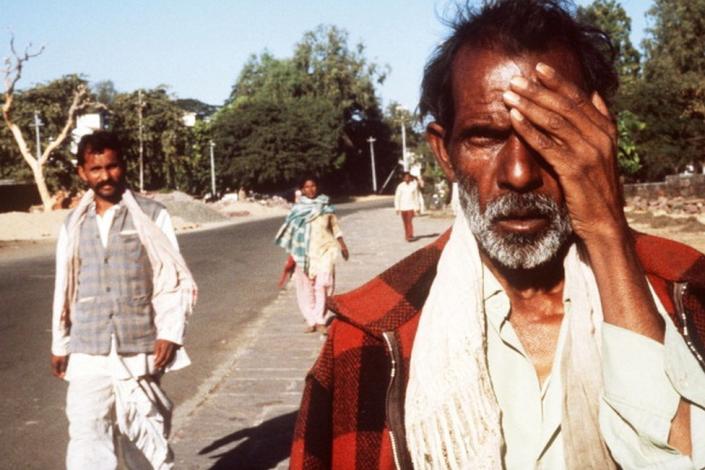 A victim of the Bhopal tragedy walks in the streets on December 04, 1984 in Bhopal where a poison gas leak from the Union Carbide factory killed thousands