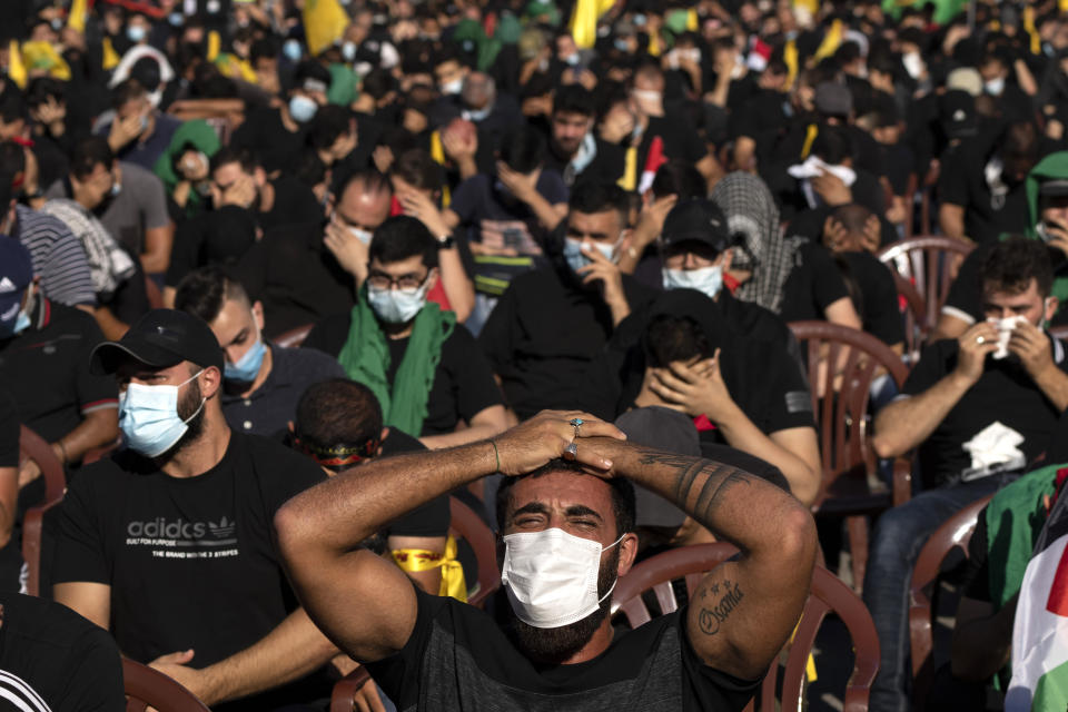 Hezbollah supporters listen to the story of Ashoura, the Shiite Muslim commemoration marking the death of Imam Hussein, the grandson of the Prophet Muhammad, at the Battle of Karbala in present-day Iraq in the 7th century, in southern Beirut, Lebanon, Thursday, Aug. 19, 2021. The leader of the militant Hezbollah group Sayyed Hassan Nasrallah said Thursday that the first Iranian fuel tanker will sail toward Lebanon "within hours" warning Israel and the United States not to intercept it. (AP Photo/ Hassan Ammar)