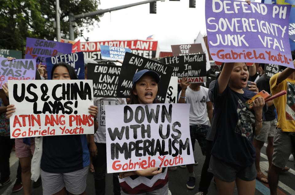 Student protesters shout slogans as they hold a protest in front of the U.S. embassy in Manila, Philippines on Tuesday, March 5, 2019. The United States is more likely to be involved in a "shooting war" in the disputed South China Sea than the Philippines but the latter would be embroiled in such a conflict just the same because of its 1951 Mutual Defense Treaty with Washington, the Philippine defense chief said Tuesday. (AP Photo/Aaron Favila)