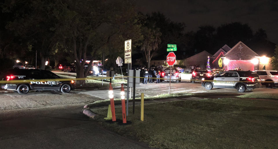 Houston police block off a Houston street after 30 people were discovered being held captive in a home 