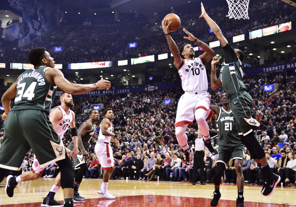 Toronto Raptors guard DeMar DeRozan (10) shoots over Milwaukee Bucks forward John Henson (31) during first half NBA basketball action in Toronto on Monday, Jan. 1, 2018. (Frank Gunn/The Canadian Press via AP)