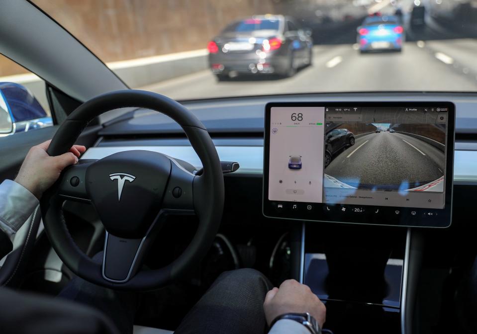 The interior of a Tesla driving down the highway