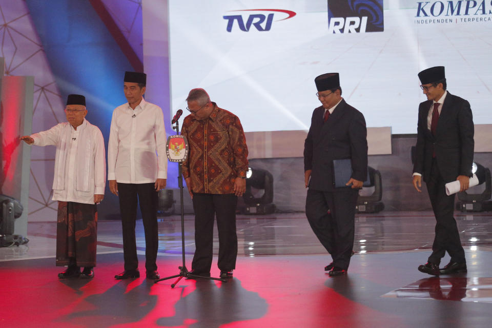 Indonesian President Joko Widodo, second left, and his running mate Ma'ruf Amin, left, and his contender Prabowo Subianto, second right, with his running mate Sandiaga Uno, right, during a televised debate in Jakarta, Indonesia, Thursday, Jan. 17, 2019. Indonesia is gearing up to hold its presidential election on April 17 that will pit the incumbent against the former general.(AP Photo/Tatan Syuflana)