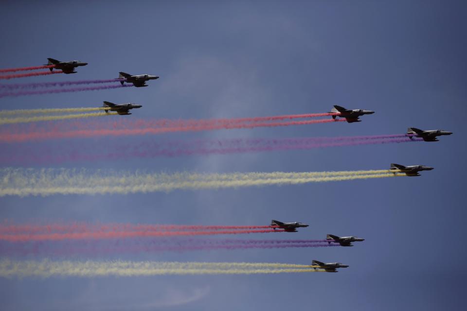 Coloured contrails are seen behind South Korean Air Force F-16 fighter jets in the sky during celebrations to mark the 65th anniversary of Korea Armed Forces Day, at a military airport in Seongnam, south of Seoul, October 1, 2013. (REUTERS/Kim Hong-Ji)