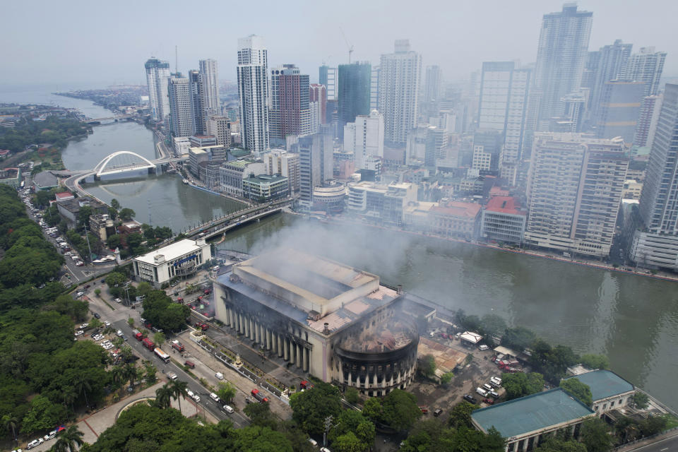 Smoke billows from the still smoldering Manila Central Post Office as a fire hits early Monday, May 22, 2023 in Manila, Philippines. A massive fire tore through Manila's historic post office building overnight, police and postal officials said Monday. (AP Photo/Aaron Favila)
