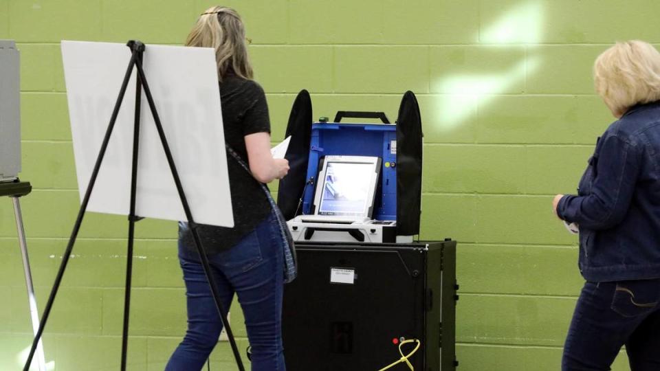 A voter walks over to scan their ballot into a new type of voting machine, first used in Kentucky’s 2022 Primary Election, Tuesday, May 17, 2022 at the Fairway precinct in Lexington, Ky. The machines, called the InterCivic are made by the Hart company. It uses a paper ballot, first filled out by the voter, and then scanned into this machine, which is nearby the voting booth.