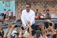 Presidential candidate Anies Baswedan greets supporters during his campaign rally in Bandar Lampung, Indonesia, Sunday, Jan. 14, 2024. The former Jakarta governor seeking Indonesia's presidency said democracy is declining in the country and pledged to make changes to get it back on track. (AP Photo/Achmad Ibrahim)