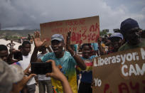 People protest for the release of kidnapped missionaries near the missionaries' headquarters in Titanyen, north of Port-au-Prince, Haiti, Tuesday, Oct. 19, 2021. A group of 17 U.S. missionaries including children was kidnapped by a gang in Haiti on Saturday, Oct. 16, according to a voice message sent to various religious missions by an organization with direct knowledge of the incident. (AP Photo/Joseph Odelyn)