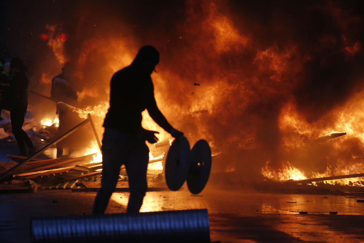 Cars burn during a demonstration on Dec. 1, 2018, in Paris against high taxes and rising fuel prices. (Photo: Chesnot/Getty Images)