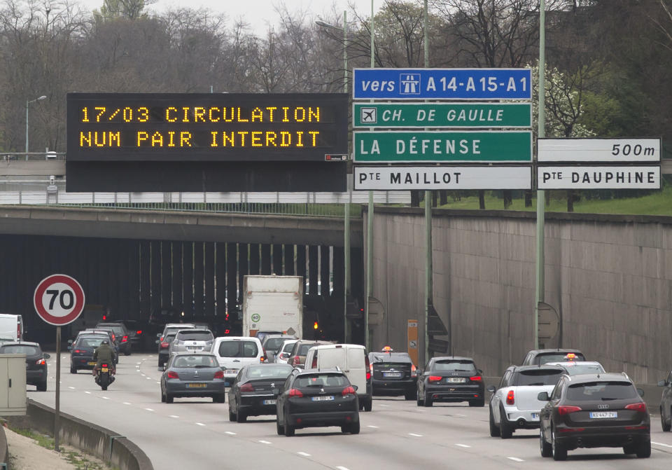 An electronic road sign on the Paris ring road reads"driving with even-numbers forbidden" in Paris, Monday, March 17, 2014. Cars with even-numbered license plates are prohibited from driving in Paris and its suburbs Monday, following a government decision over the weekend. Paris is taking drastic measures to combat its worst air pollution in years, banning around half of the city's cars and trucks from its streets in an attempt to reduce the toxic smog that's shrouded the City of Light for more than a week. (AP Photo/Michel Euler)