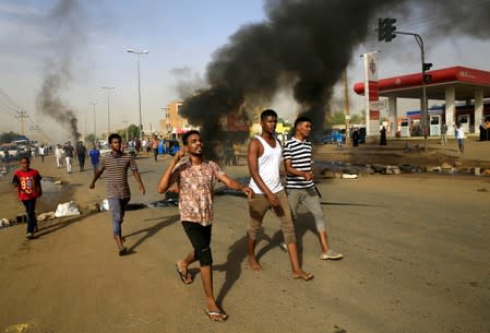Sudanese protesters chant slogans along a street and demanding that the country's Transitional Military Council hand over power to civilians in Khartoum,