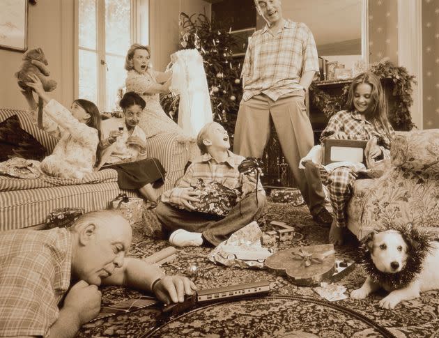 Christmas Day in chaotic family living room  (toned Polaroid B&W) (Photo: Frank Herholdt via Getty Images)