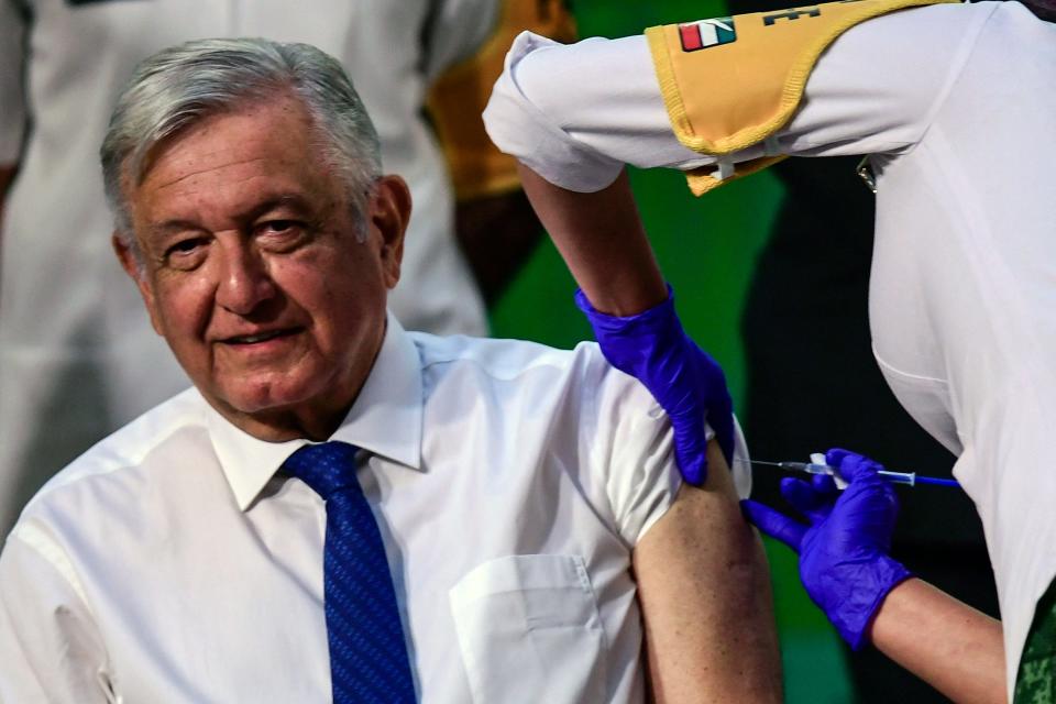 Mexican President Andres Manuel Lopez Obrador is inoculated with the first dose of the Astra Zeneca vaccine against COVID-19 after his daily morning press conference at the National Palace in Mexico City on April 20, 2021. (Photo by PEDRO PARDO / AFP) (Photo by PEDRO PARDO/AFP via Getty Images)