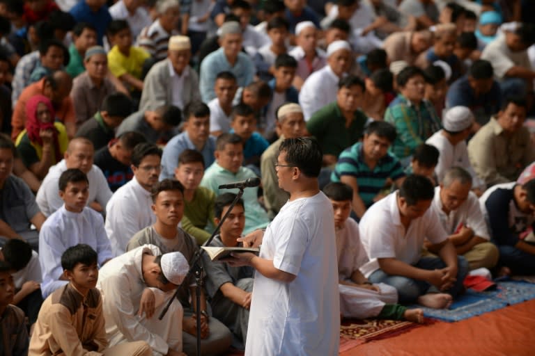 An imam delivers a sermon during an Eid al-Fitr prayer on the grounds of the city hall in Iligan City on the southern island of Mindanao