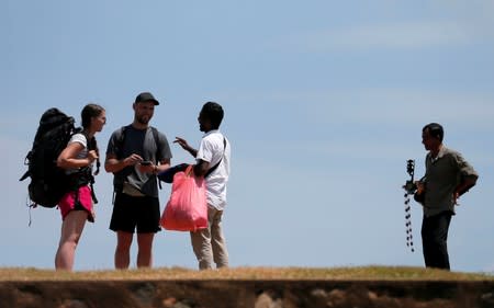 Local vendors try to sell their handmade items to tourists at a Dutch Fort in Galle