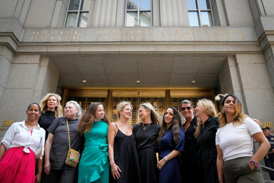 Sexual assault victims share smiles as they gather for a group photograph after sentencing proceedings concluded for convicted sex offender Robert Hadden outside Federal Court, Tuesday, July 25, 2023, in New York. (AP Photo/John Minchillo)