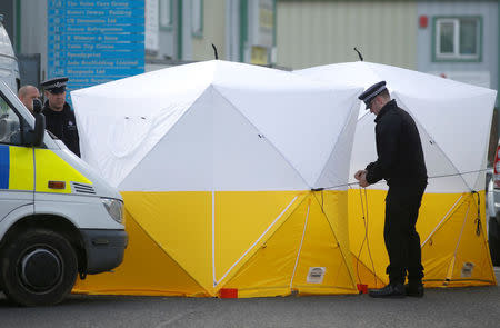 Police officers erect a forensic tent at a car recovery depot in Norton Enterprise Park, where Sergei Skripal's car was originally transported, in Salisbury, Britain, March 13, 2018. REUTERS/Henry Nicholls